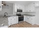 Bright kitchen with stainless steel appliances, granite countertops, and white cabinets at 135 Kimbell Farm Dr, Locust Grove, GA 30248