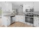 Bright kitchen with stainless steel appliances, white cabinets, and granite countertops at 135 Kimbell Farm Dr, Locust Grove, GA 30248