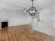 Open living area showcasing hardwood floors, fireplace, modern lighting, and a breakfast bar at 135 Kimbell Farm Dr, Locust Grove, GA 30248
