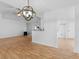 Open-concept living area with wood floors, breakfast bar, ceiling fan, and modern lighting at 135 Kimbell Farm Dr, Locust Grove, GA 30248