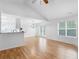 Bright open-concept living area with wood floors, vaulted ceilings, and French doors to the backyard at 135 Kimbell Farm Dr, Locust Grove, GA 30248