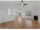 Spacious living room features wood floors, a fireplace, and plenty of natural light at 135 Kimbell Farm Dr, Locust Grove, GA 30248