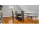 Attic area with a dark wood table, chairs, shelves and hardwood floors at 2114 Castlewycke Ct, Marietta, GA 30068