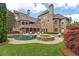 Spacious backyard with in-ground pool, spa, fire pit, and ample seating areas at 2114 Castlewycke Ct, Marietta, GA 30068