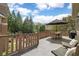 Outdoor deck with a dining table, lounge chairs, and lush greenery at 2114 Castlewycke Ct, Marietta, GA 30068