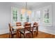 Bright dining area with wooden table set and natural light through shuttered windows at 2114 Castlewycke Ct, Marietta, GA 30068