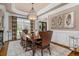 Elegant dining room with decorative chandelier, large wooden table, and sophisticated decor at 2114 Castlewycke Ct, Marietta, GA 30068