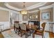 Formal dining room with elegant lighting, hardwood floors, and traditional decor at 2114 Castlewycke Ct, Marietta, GA 30068