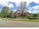 Charming brick home with lush landscaping, mature trees, and well-maintained lawn at 2114 Castlewycke Ct, Marietta, GA 30068