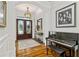 Inviting foyer with hardwood floors and elegant front door design, plus grand piano at 2114 Castlewycke Ct, Marietta, GA 30068