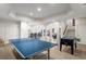 Spacious game room includes a ping pong table, foosball, and access to a staircase at 2114 Castlewycke Ct, Marietta, GA 30068