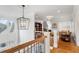 Hallway features wrought iron railing, overhead lantern, and view into another living space at 2114 Castlewycke Ct, Marietta, GA 30068