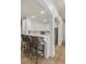 Eat-in kitchen features white cabinets and stools at the bar at 2114 Castlewycke Ct, Marietta, GA 30068