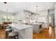 Open kitchen with island seating, white cabinets, and hardwood floors at 2114 Castlewycke Ct, Marietta, GA 30068