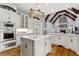 Modern kitchen with stainless steel appliances, center island and stone fireplace at 2114 Castlewycke Ct, Marietta, GA 30068