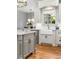 Bright kitchen with stainless steel appliances, farm sink, and hardwood floors at 2114 Castlewycke Ct, Marietta, GA 30068