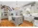 Spacious kitchen with stone fireplace, island with microwave, and hardwood floors at 2114 Castlewycke Ct, Marietta, GA 30068
