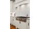 Gourmet kitchen featuring stainless steel stove and custom range hood and white cabinets at 2114 Castlewycke Ct, Marietta, GA 30068
