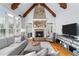 Bright living room featuring hardwood floors, a fireplace, and beamed cathedral ceiling at 2114 Castlewycke Ct, Marietta, GA 30068