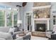 Bright living room featuring hardwood floors, large windows, and a stone fireplace at 2114 Castlewycke Ct, Marietta, GA 30068