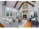 Bright living room featuring hardwood floors, large windows, a fireplace, and beamed cathedral ceiling at 2114 Castlewycke Ct, Marietta, GA 30068