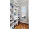 Walk-in pantry with custom shelves and a window to let in natural light at 2114 Castlewycke Ct, Marietta, GA 30068