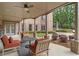 Relaxing covered patio featuring comfortable seating and ceiling fan in this brick home at 2114 Castlewycke Ct, Marietta, GA 30068