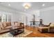 Sitting room featuring hardwood floors, comfortable seating, and natural light from the shutters at 2114 Castlewycke Ct, Marietta, GA 30068