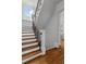 Elegant staircase with wooden treads, white risers, and a decorative wrought iron railing at 2114 Castlewycke Ct, Marietta, GA 30068