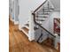 Elegant staircase features dark wood banister, detailed iron spindles and hardwood floors at 2114 Castlewycke Ct, Marietta, GA 30068