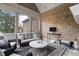 Cozy sun room featuring exposed brick, comfortable seating, and ample natural light at 2114 Castlewycke Ct, Marietta, GA 30068