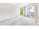 Serene bedroom with plush gray carpet and sliding door access to private balcony at 244 13Th Ne St # 310, Atlanta, GA 30309