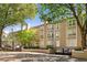 Three-story building exterior with well-maintained landscaping at 244 13Th Ne St # 310, Atlanta, GA 30309