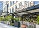 Restaurant patio with outdoor seating, potted plants, and awning at 244 13Th Ne St # 310, Atlanta, GA 30309