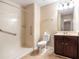 Bathroom featuring a walk-in shower with grab bars, dark wood vanity, and a toilet at 4312 Defoors Farm Trl, Powder Springs, GA 30127