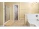A bathroom featuring tile floors, shower, and a large soaking tub at 4312 Defoors Farm Trl, Powder Springs, GA 30127