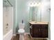 Cozy bathroom featuring a shower/tub combo, vanity with dark wood cabinets, and a toilet at 4312 Defoors Farm Trl, Powder Springs, GA 30127