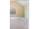 A bedroom with neutral carpeting, pale yellow walls, and a vaulted ceiling at 4312 Defoors Farm Trl, Powder Springs, GA 30127