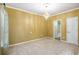 Cozy bedroom with carpet flooring, chandelier lighting, and access to an en-suite bathroom for comfort at 4312 Defoors Farm Trl, Powder Springs, GA 30127