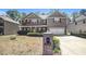 Charming two-story brick home featuring a front porch, attached garage, and a well-manicured lawn at 4312 Defoors Farm Trl, Powder Springs, GA 30127