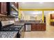 Kitchen view showcasing granite countertops, stainless steel appliances and dark wood cabinets at 4312 Defoors Farm Trl, Powder Springs, GA 30127