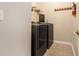 Convenient laundry room with modern washer and dryer units and storage space at 4312 Defoors Farm Trl, Powder Springs, GA 30127