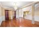 Elegant living room featuring hardwood floors, decorative columns, and a staircase, perfect for entertaining at 4312 Defoors Farm Trl, Powder Springs, GA 30127