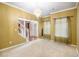 Inviting living room with plush carpeting, elegant chandelier, and a view of staircase for added charm at 4312 Defoors Farm Trl, Powder Springs, GA 30127