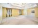 A large main bedroom features a tray ceiling, ceiling fan, and neutral carpeting at 4312 Defoors Farm Trl, Powder Springs, GA 30127