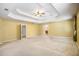 A large main bedroom features a tray ceiling, ceiling fan, and ensuite bathroom access at 4312 Defoors Farm Trl, Powder Springs, GA 30127