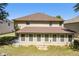 Back exterior of a home featuring a sunroom, and a well-maintained lawn with mature trees at 4312 Defoors Farm Trl, Powder Springs, GA 30127