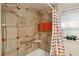 Bathroom features a neutral tile shower, grab bar, and decorative shower curtain at 702 Argonne Ne Ave # 1, Atlanta, GA 30308