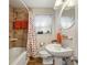 Bathroom featuring a shower, tub, and a pedestal sink with neutral decor at 702 Argonne Ne Ave # 1, Atlanta, GA 30308
