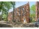 Exterior elevation of a red brick apartment building surrounded by mature trees at 702 Argonne Ne Ave # 1, Atlanta, GA 30308